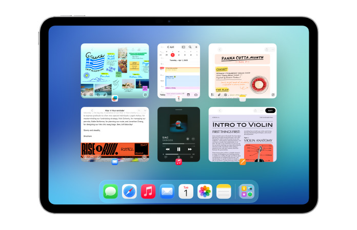 iPad i liggande läge, skärmen visar flera appar som Kalender och Musik i sex fönster i två rader så att fönstren syns lika mycket